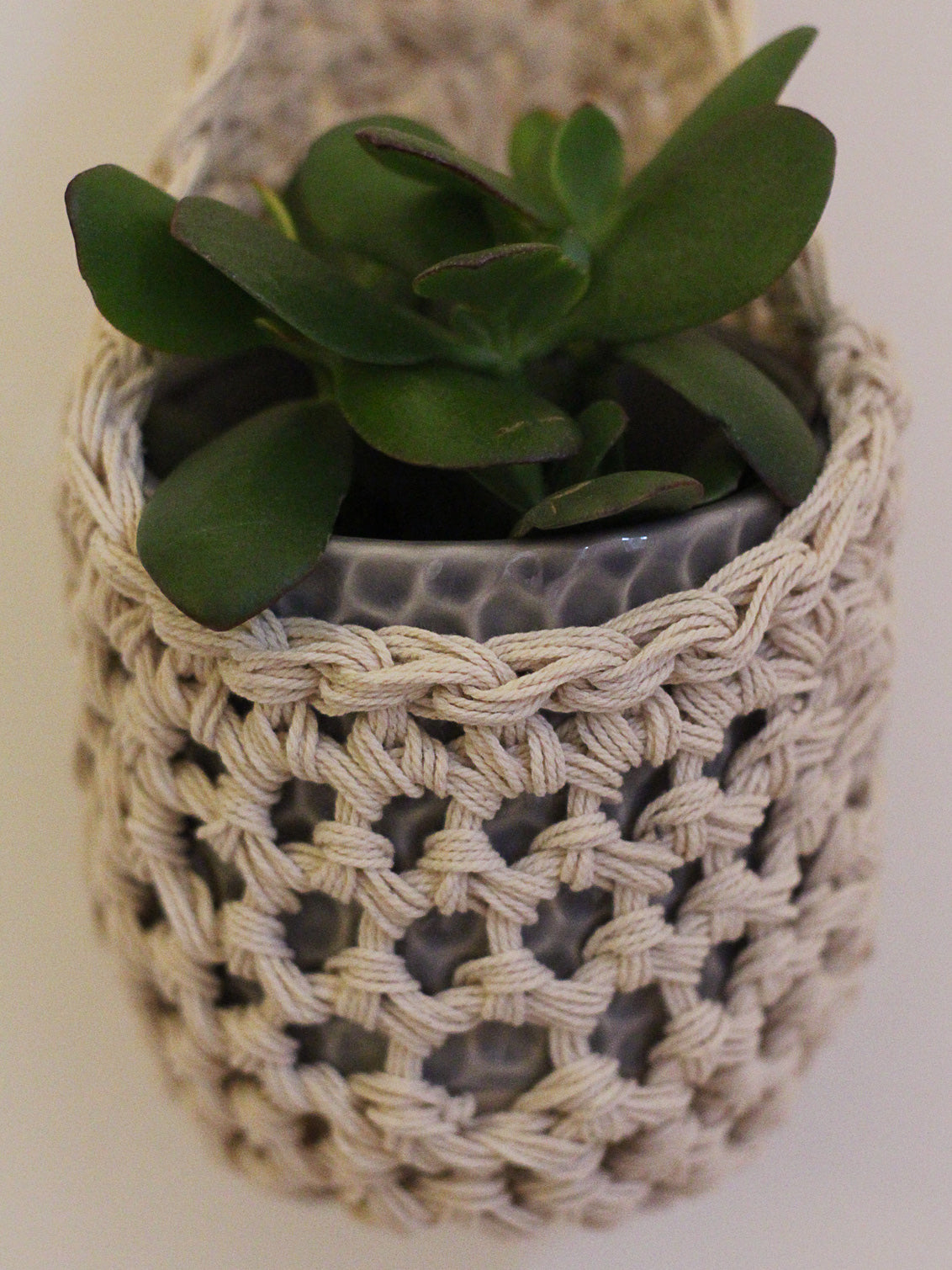Image showing close rochet details of tierdrop shape cotton plant hanger, containing pot and plant. To give an idea of how the planter would look in situ.