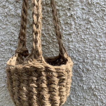 Photo showing the natural jute hanging plant holder without ceramic pot or plant. Designed to demonstrate the shape of thew lower part of the basket on it's own.