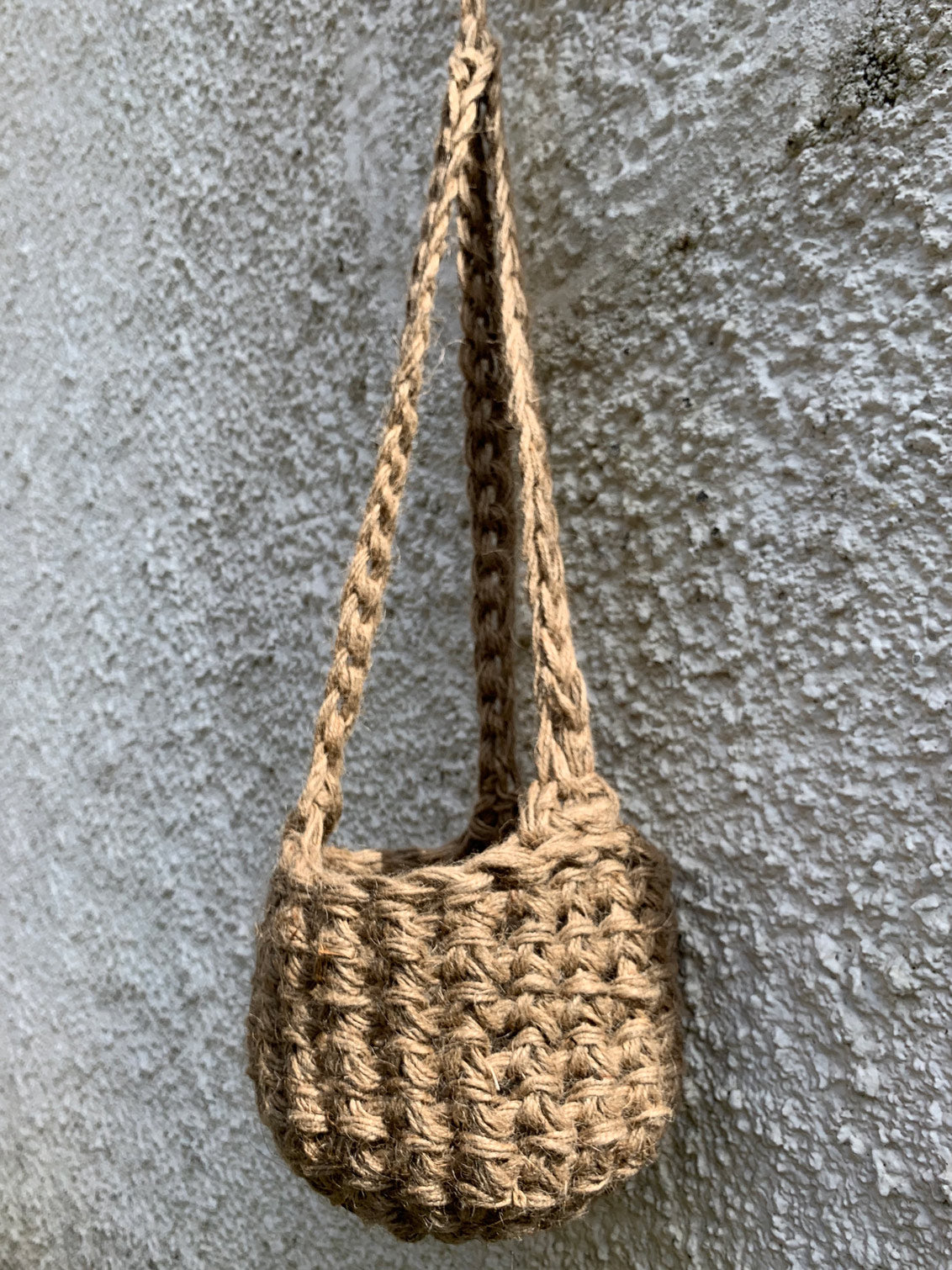 Photo showing the natural jute hanging plant holder without ceramic pot or plant. Designed to demonstrate the shape of thew lower part of the basket on it's own.