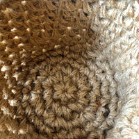 Photo showing close up interior view of standing jute plant basket. Demonstrates the crocheted texture and the construction of the basket.
