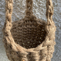 Photo showing the natural jute hanging plant holder without ceramic pot or plant. Designed to demonstrate the shape of thew lower part of the basket on it's own.