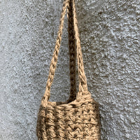 Photo showing the natural jute hanging plant holder without ceramic pot or plant. Designed to demonstrate the shape of thew lower part of the basket on it's own.